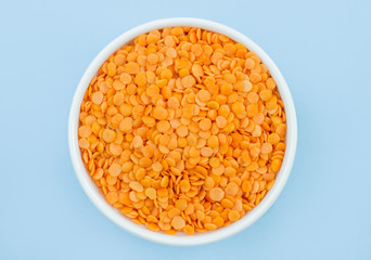 lentils in a plate on top, on a blue background, copy space