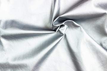 Concept for leather, textile and texture - closeup of crumpled gray silver metallic leather, fabric background