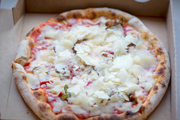 Pizza margarita in box with parmesan cheese 