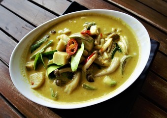 Mushroom Green Curry, popular Thai dish on the wooden table background, Huahin Thailand.