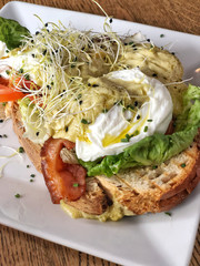 Egg Benedict with ham and salad on a toast bread