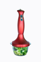 kitchen hand blender with a bowl filled with fruits and vegetables for making vitamin smoothies. isolated on white background