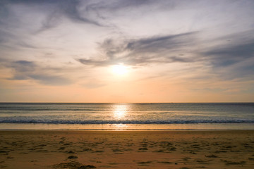 the sun goes over the horizon on the beach