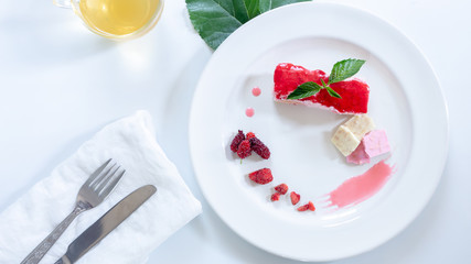 Cake strawberry yogurt with tea on white backgrounds