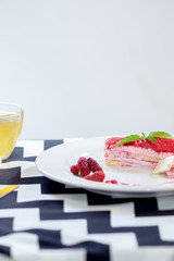 Cake strawberry yogurt with tea on white backgrounds