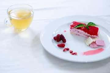 Cake strawberry yogurt with tea on white backgrounds