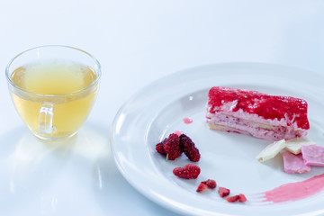 Cake strawberry yogurt with tea on white backgrounds