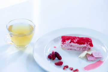 Cake strawberry yogurt with tea on white backgrounds