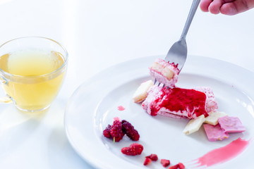 Cake strawberry yogurt with tea on white backgrounds