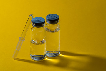 Medicine bottles and pipette on a yellow background. Medicines for individual preparation. Drip medicine. Dropper glass. Bottle Mock-Up