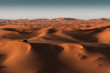 Fototapeta na wymiar Incredible sunset in the Sahara desert, the sun goes down and the dunes become orange