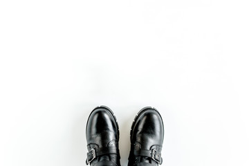 Black female boots on white  background. Flat lay, top view minimal background. Fashion blog or magazine concept.