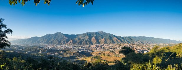 Panoramic aerial view of Caracas during a sunset - obrazy, fototapety, plakaty