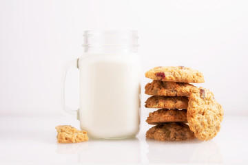 cookies and milk on white glass surface