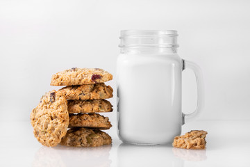 cookies and milk on white glass surface