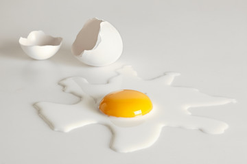 Broken egg on white background (selective focus)