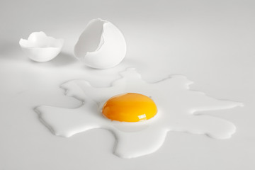Broken egg on white background (selective focus)