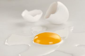 Broken egg on white background (selective focus)