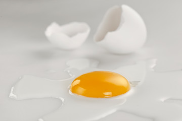 Broken egg on white background (selective focus)