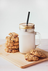 oatmeal cookies with milk on a light background