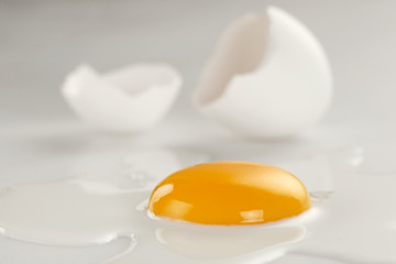 Broken egg on white background (selective focus)