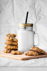 oatmeal cookies with milk on a white background
