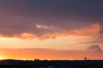 Sunrise behind clouds scene
