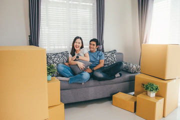 Happy young couple enjoying together moving in a new house.