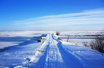 Bridge covered with snow in the winter field