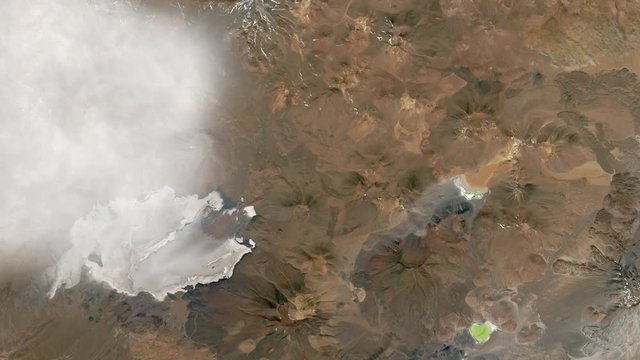 Llullaillaco volcano aerial satellite view with moving clouds. Contains public domain image by Nasa