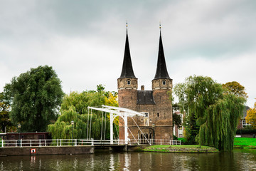 city gate with towers, lifting bridge and water in Delft, The Netherlands