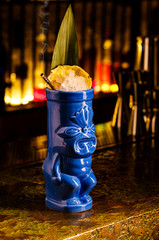 Tropical cocktail tiki bar style.  Alcoholic, non-alcoholic drink-beverage at the bar