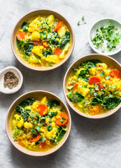 Lentils, turmeric, vegetables potatoes, carrots, cauliflower, turnips vegetarian soup on a light background, top view. Healthy food concept