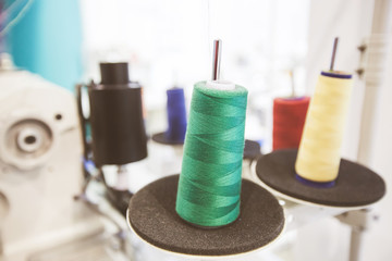 Colorful sewing threads spools at textile workshop
