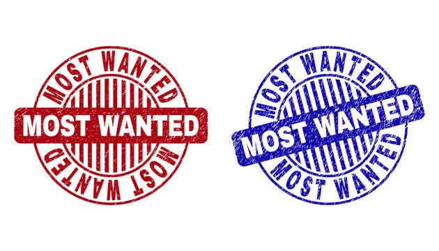 Grunge MOST WANTED round stamp seals isolated on a white background. Round seals with distress texture in red and blue colors.