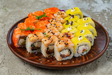 Rainbow Sushi Roll with salmon, eel, tuna, avocado, royal prawn, cream cheese Philadelphia, caviar tobica, chuka. Sushi menu. Japanese food