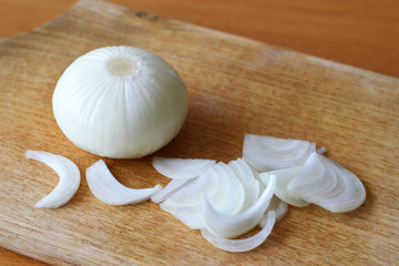 Onion on wooden cutting board