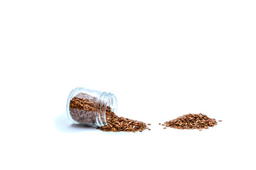 Isolated photo. Flax seeds in a glass jar on a white background. Healthy food, diet for weight loss.
