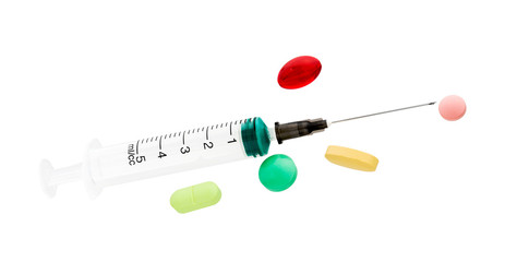Syringe close-up. Medical syringe and pill