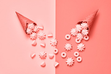 Ice Cream cone with Candy Sweets desert. Fashion Flat lay. Marshmallow, meringue background. Party, birthday holiday firework. Pastel coral Color. Trendy creative art Style. Minimal sweet concept