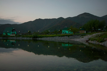 Fototapeta premium Beautiful clouds flying over the lake near mountains. Evening time shot over the clouds. Azerbaijan. Big Caucasus