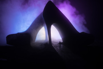 Artwork decoration. Silhouette of a man standing in the middle of the road on a misty night with...