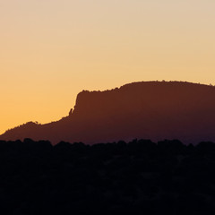 An iconic mountain in the southwest baths in golden hour light