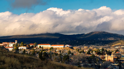 Golden hour light shines on a university in a small mountain town - 259947986
