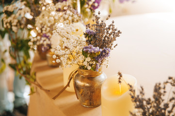 Wedding decorations in rustic style. Candles flowers on the sill of window