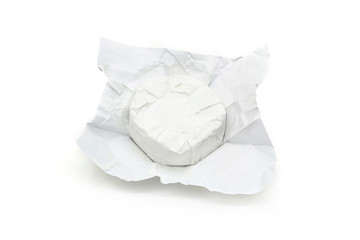 Soft cheese with white mold Brie in unwrapped packaging