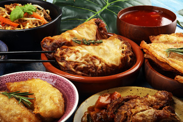 Assorted Chinese food set. Chinese noodles, fried rice, peking duck, dim sum, spring rolls. Famous Chinese cuisine dishes on table. Chinese restaurant concept. 