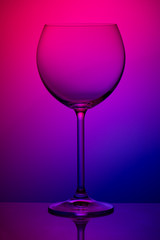 Wineglass on colorful background