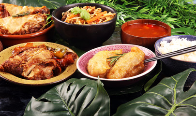 Assorted Chinese food set. Chinese noodles, fried rice, peking duck, dim sum, spring rolls. Famous Chinese cuisine dishes on table. Chinese restaurant concept. 