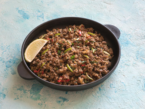 Indian minced meat Qeema on a blue table. 